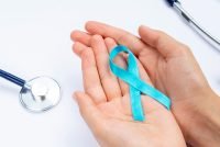 close-up-hands-holding-blue-ribbon-with-stethoscope.jpg