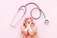 white-awareness-ribbon-two-hands-with-stethoscope-pink-background.jpg